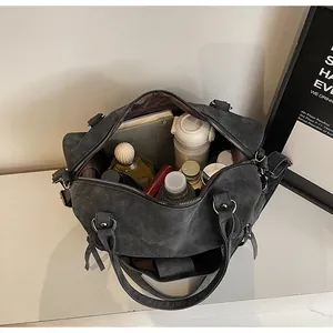 Spacious interior of retro dark grey frosted tote bag with daily items and strap