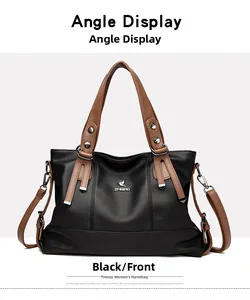 Close-up of black lychee-grain leather tote bag with brown straps and silver metal hardware