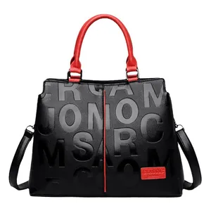 Classic black leather handbag for women with red circular handles and embossed texture