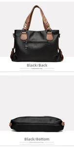 Detail view showing back zipper pocket and bottom base of large black tote bag