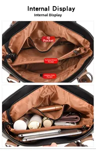 Internal view showing compartments and storage capacity for essentials in black leather bag