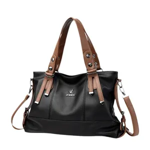 Large black pebbled leather handbag with brown handles and silver bird logo