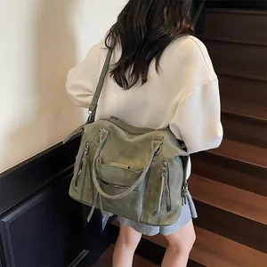 Retro large green matte tote bag with fringe zippers shown on a model outdoors