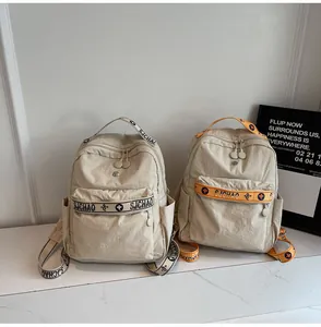 Detail of dual casual backpacks featuring contrast webbing straps and durable nylon fabric