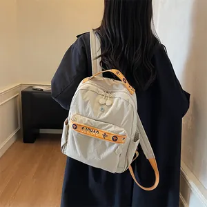 Minimalist cream nylon travel backpack with orange straps and floral pattern accents