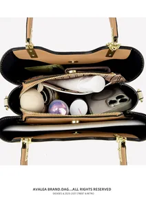 Top view of spacious leather handbag interior showing multi-compartment storage and gold zipper