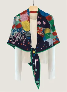 Detailed view of dark blue floral horse print scarf draped over a white dress shirt