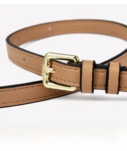 Close-up of elegant light brown leather belt with a polished gold rectangular buckle