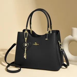 Classic black leather tote handbag with gold kangaroo logo and heart pendant charm