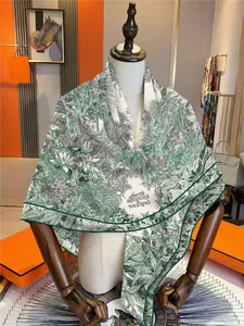 Detail view of large cashmere blend botanical garden print shawl on a wooden mannequin