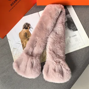 Detailed texture of pink faux fur scarf on fashion magazine and orange luxury bag