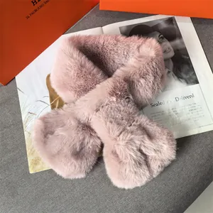 Pink faux fur plush scarf with cross-pull design on a stylish fashion magazine background