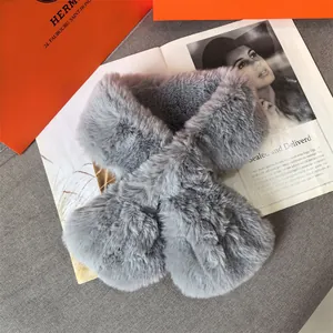 Detail of soft grey faux fur scarf showing plush texture and cross-over design