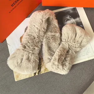 Detailed macro of beige plush scarf with folded ends and soft faux fur texture