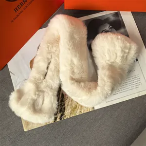 Detail shot of a soft white plush faux fur scarf styled with a fashion magazine background