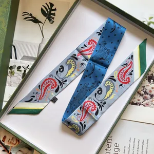 Blue paisley twilly scarf with leopard print texture on green luxury gift box