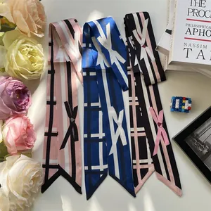Three elegant faux silk skinny scarves with bow print in pink, blue and black colors