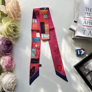 Detail of fuchsia Twilly scarf with vintage ticket patterns and elegant finished edges
