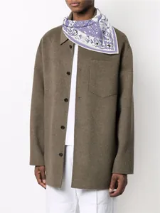 Detail of lavender paisley silk scarf with hand-rolled edges on olive wool coat