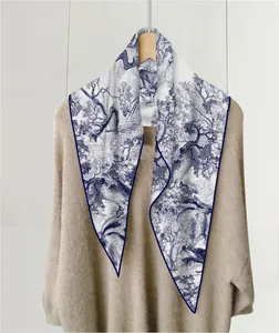 Detailed view of the blue Toile de Jouy jungle print on a soft cashmere-feel scarf