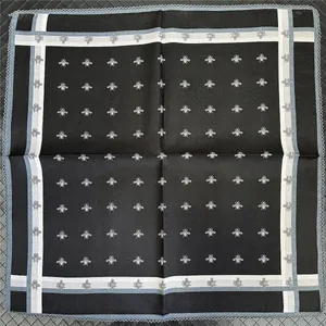 Square black scarf with white bee prints and light blue lace trim edges