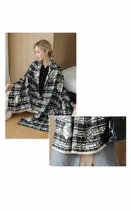 Detail of soft cashmere feel fabric with black and white plaid and rose patterns