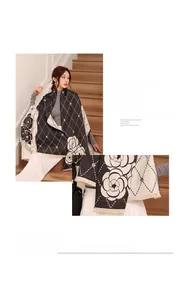 Detailed view of imitation cashmere scarf featuring camellia pattern and tassel edges
