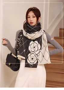 Close-up of camellia and lattice pattern on thick cashmere-like scarf with fringe