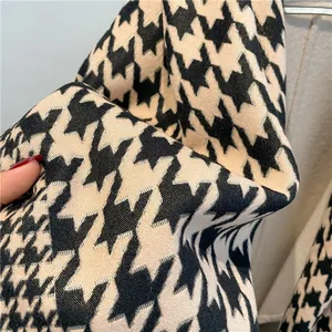 Close-up of thick houndstooth pattern fabric with high-density knit texture