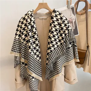 Detail shot of black and white houndstooth scarf with elegant tassel fringe edge