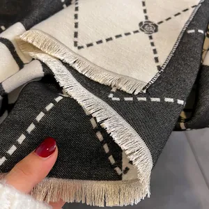 Close-up of camellia pattern scarf showing diamond knit texture and fringe edge details