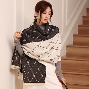 Close-up of camellia pattern scarf with color block design and fringed edge