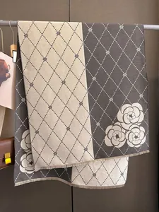 Detailed view of jacquard camellia flower pattern on thick faux cashmere winter scarf