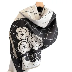 Thick camellia pattern scarf with diamond lattice and tassels on a wooden hanger