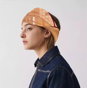 Detail of orange geometric silk scarf on blue denim jacket for elegant styling