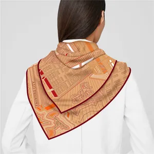 Detail of orange printed silk scarf with architectural patterns on white blazer