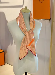 Detail of elegant orange geometric print silk scarf tied on a mannequin with gift packaging