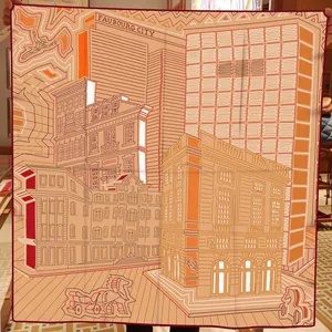Detailed shot of Faubourg City print silk scarf with orange and brown geometric patterns