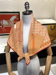 Detailed close-up of orange silk scarf with horse and classical architecture prints