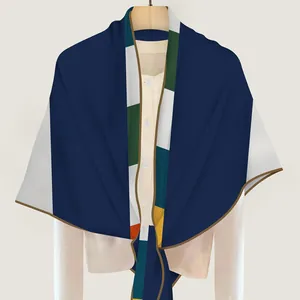 Silk-textured winter scarf with geometric patchwork design on beige shirt model