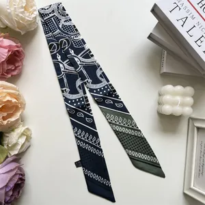 Detailed view of dark blue and army green faux silk scarf with paisley and horse bit motifs