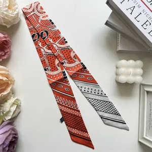 Detail of elegant orange and silver-grey silk scarf with vintage geometric patterns