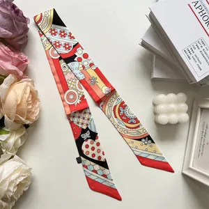 Detail of colorful twill silk twilly scarf with floral geometric pattern on white background