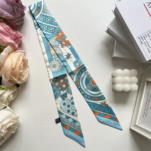 Detailed macro view of twilly silk scarf with floral bee patterns and care label