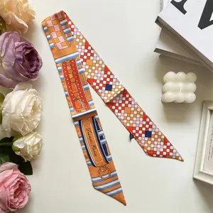 Detail of vibrant orange silk twilly with geometric patterns and France-Paris print