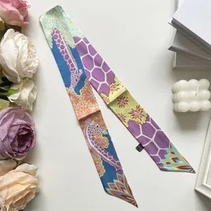 Detail of artistic giraffe print twilly scarf with elegant floral pattern on white background