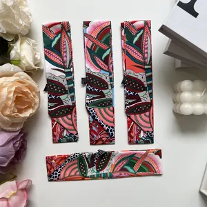Detailed set of four twilly scarves with floral patterns for bag handle decoration