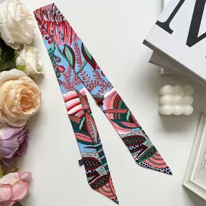 Macro detail of a colorful floral twilly silk scarf with decorative brand washing label