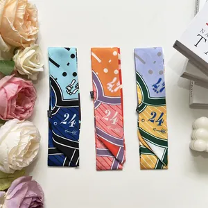 Detailed macro view of woven silk scarves for bag handles in three assorted color patterns
