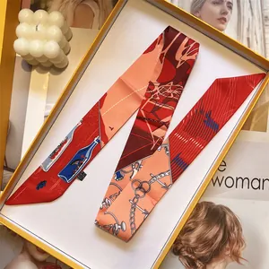 Detail of nautical print twilly scarf with anchors and ship patterns in a luxury gift box